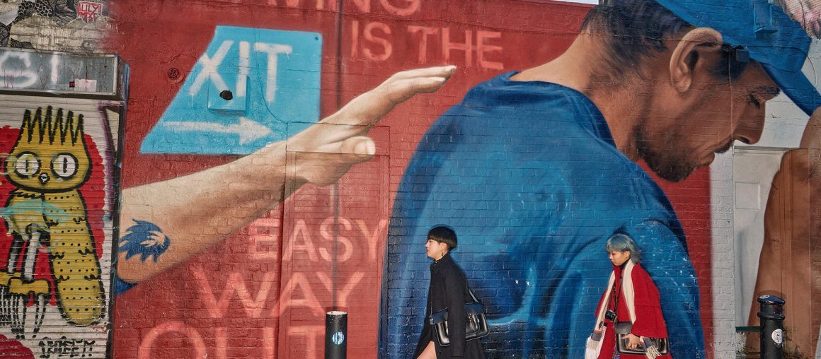 Dougie Wallace aims his flashgun at Brick Lane in a new photo book