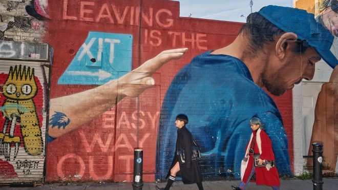 Dougie Wallace aims his flashgun at Brick Lane in a new photo book
