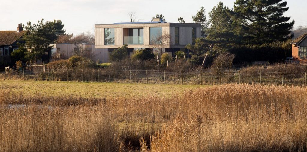 RX Architects builds larch-clad house that cantilevers over landscape