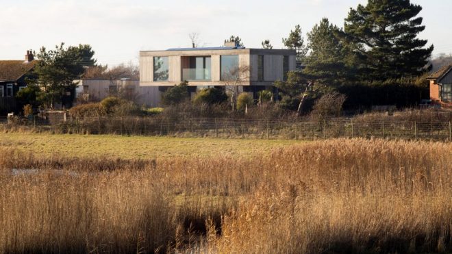 RX Architects builds larch-clad house that cantilevers over landscape