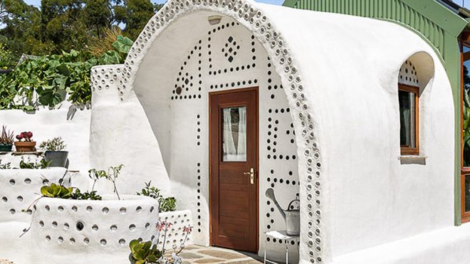 Whimsical, off-grid earthship is made out of reclaimed tires and bottles