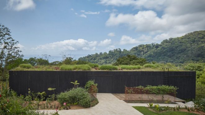 Green roof and charred wood blend Atelier Villa into Costa Rican jungle