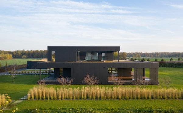 Medusa Group completes black house clad with graphite-coloured composite panels in Poland