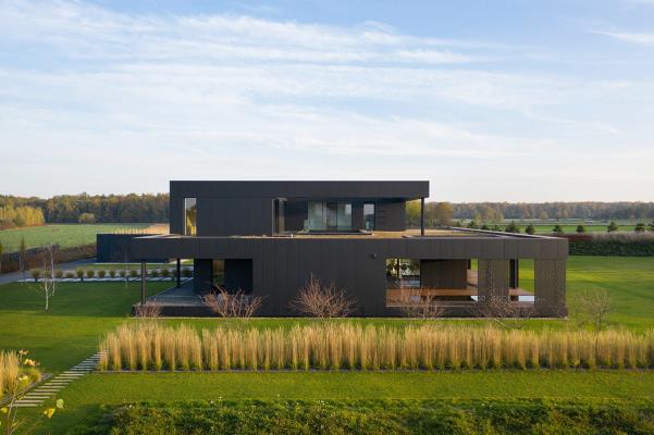 Medusa Group completes black house clad with graphite-coloured composite panels in Poland