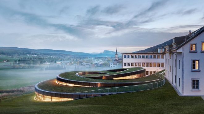 BIG’s swirling watch museum opens in the Swiss mountains