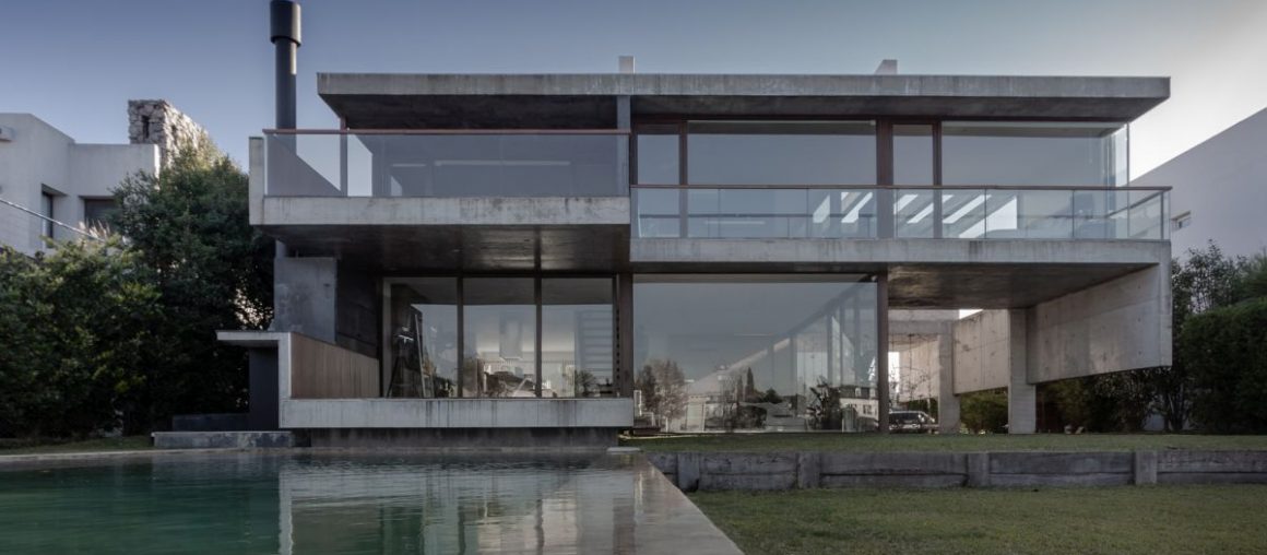 Exposed Concrete and Glass House On a Beautiful Lake Shore