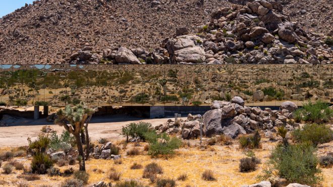 The Invisible House is a reflective building that mirrors its desert surroundings