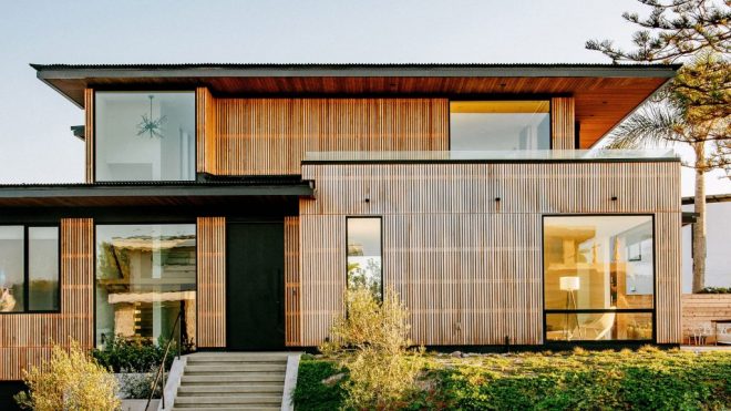 Overhanging roofs shade outdoor areas of cedar-clad Seaside Reef House
