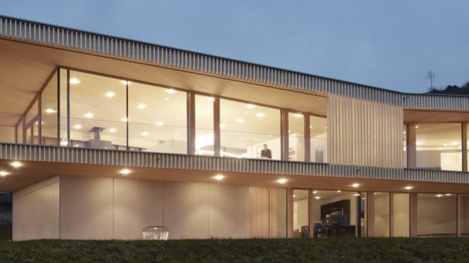 Geothermal-powered timber home glows by an Austrian lake
