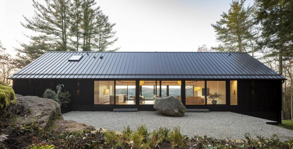 A Lovely Wooden House On A Big Rock Ledge