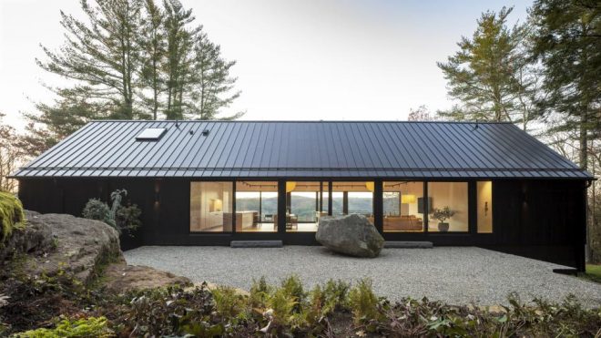 A Lovely Wooden House On A Big Rock Ledge