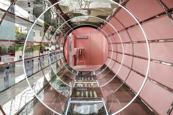 Nax Architects created pop-up shop that features pinkish time tunnel for tea cosmetics brand